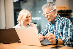 Couple at laptop computer learning to earn an income online