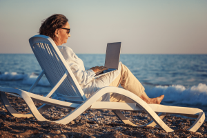 Woman on laptop on beach